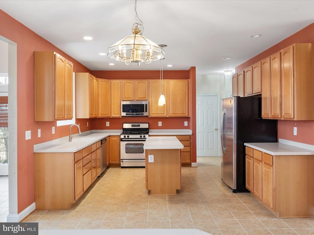 kitchen with appliances with stainless steel finishes, a kitchen island, sink, hanging light fixtures, and a notable chandelier