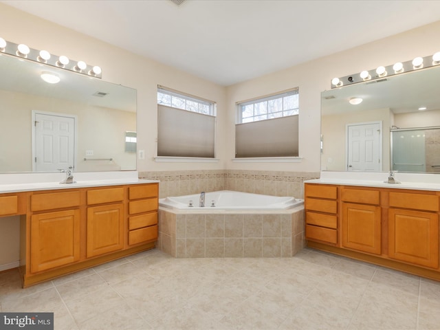 bathroom featuring tile patterned flooring, shower with separate bathtub, and vanity