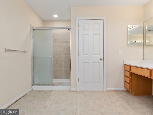 bathroom featuring vanity, tile patterned flooring, and a shower with door