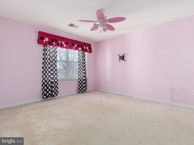 empty room with ceiling fan and light colored carpet