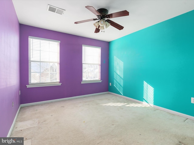 empty room featuring light carpet and ceiling fan