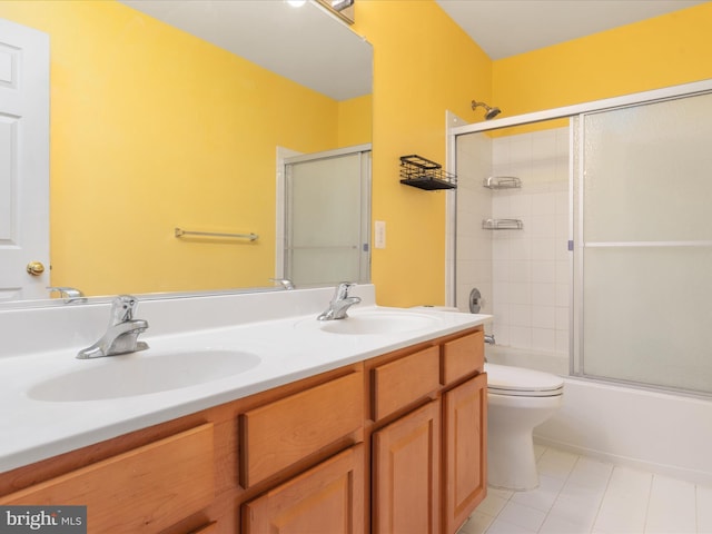 full bathroom with toilet, bath / shower combo with glass door, tile patterned flooring, and vanity