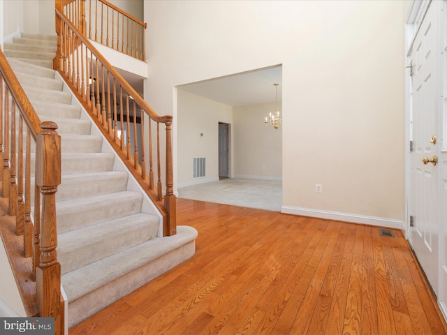 foyer with light hardwood / wood-style flooring and a notable chandelier