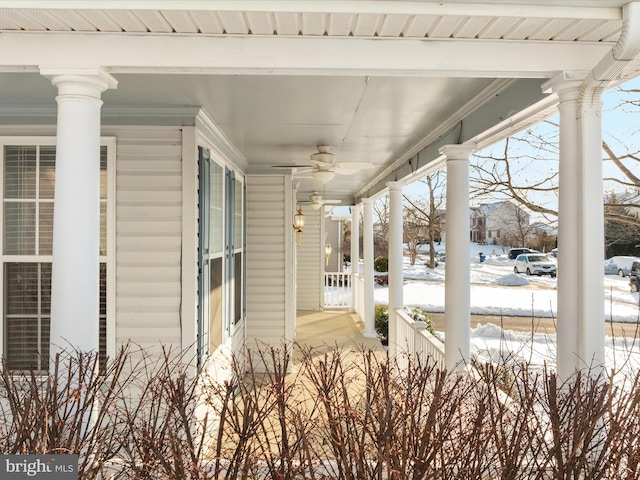 snow covered patio featuring ceiling fan