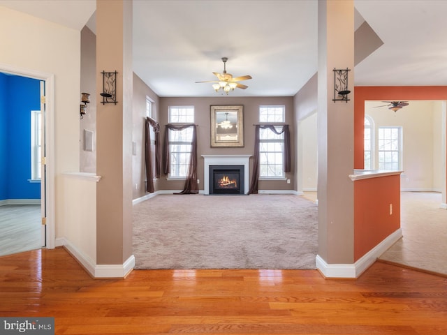 unfurnished living room featuring light hardwood / wood-style floors and ceiling fan