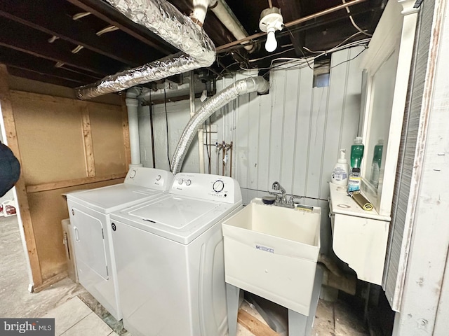 laundry area featuring washing machine and dryer and sink