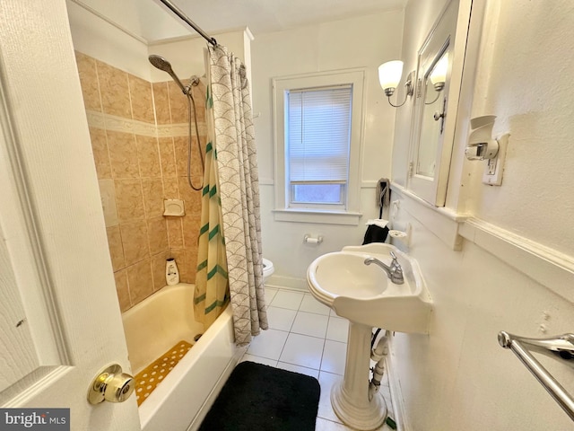 bathroom featuring tile patterned floors, shower / bath combination with curtain, and toilet