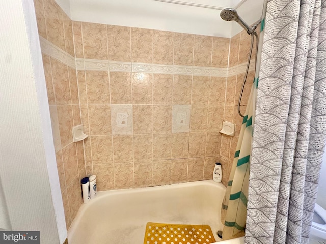 bathroom with shower / bath combo with shower curtain