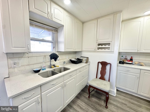 kitchen featuring decorative backsplash, sink, and white cabinets