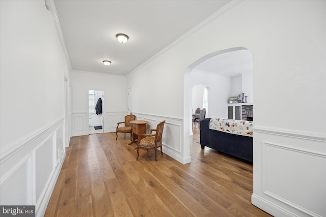 interior space featuring ornamental molding and light wood-type flooring