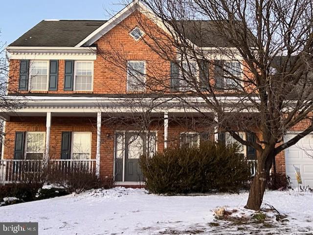 view of front of home with a garage and a porch