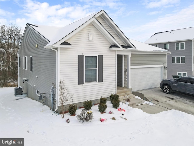 view of front of property with central AC unit and a garage