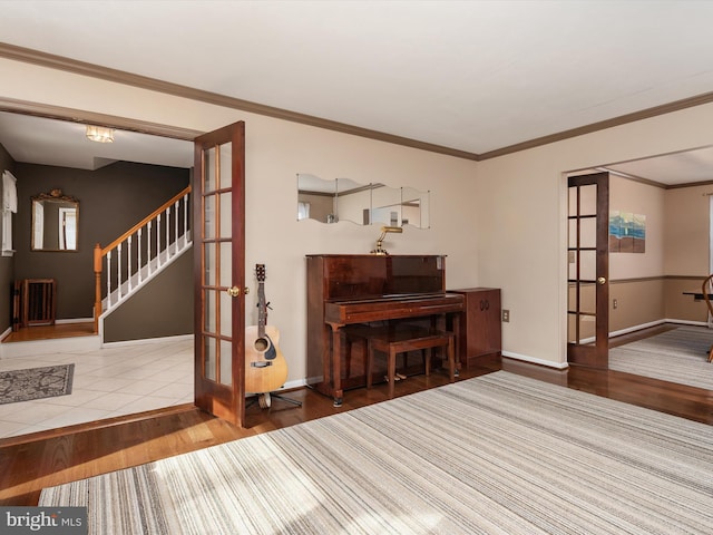 miscellaneous room featuring french doors, ornamental molding, and hardwood / wood-style floors