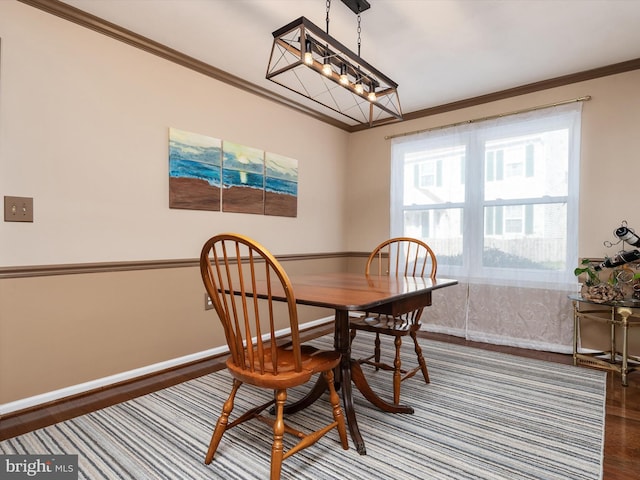 dining space with crown molding and hardwood / wood-style flooring