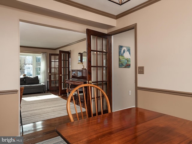 dining space with crown molding and hardwood / wood-style flooring