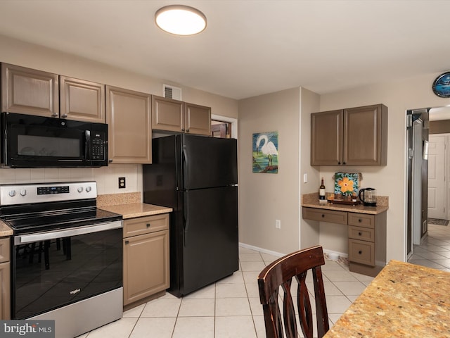 kitchen with tasteful backsplash, light stone countertops, light tile patterned floors, and black appliances