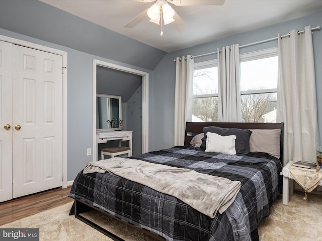 bedroom featuring ceiling fan, vaulted ceiling, and light hardwood / wood-style flooring