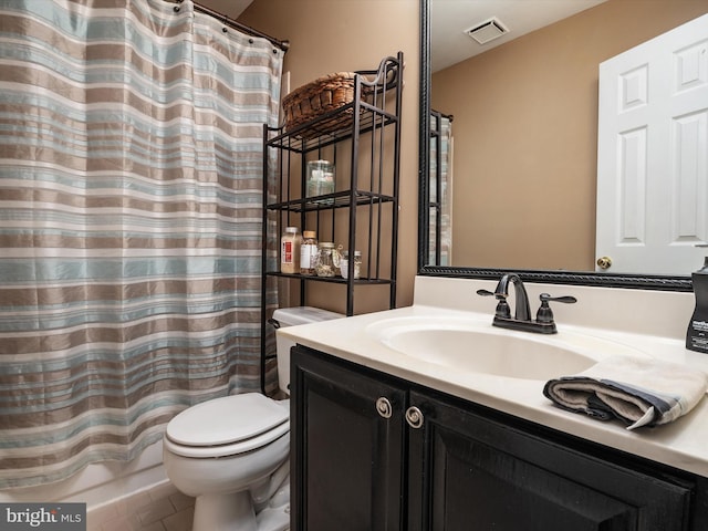 bathroom featuring vanity, toilet, and tile patterned flooring