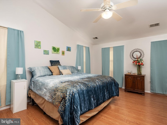 bedroom with vaulted ceiling, ceiling fan, and light hardwood / wood-style floors