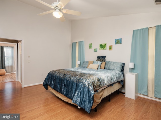 bedroom featuring ceiling fan, lofted ceiling, and light hardwood / wood-style floors