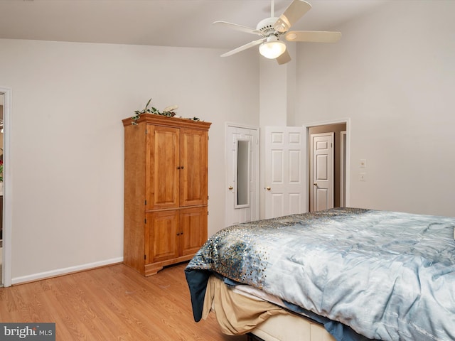 bedroom with high vaulted ceiling, ceiling fan, and light hardwood / wood-style floors