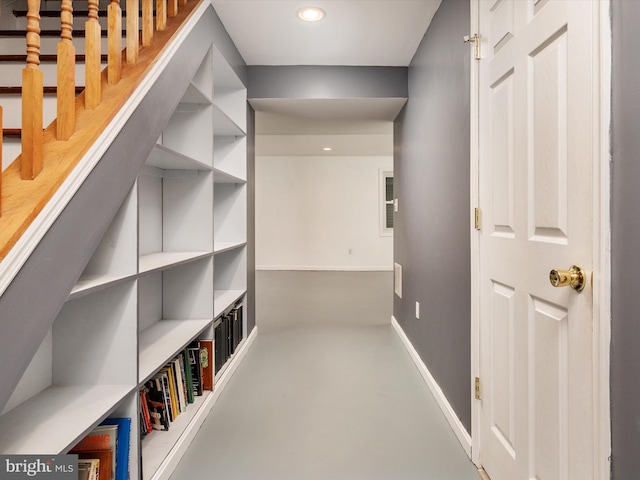 hallway with concrete flooring