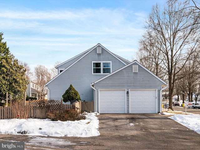 view of snowy exterior with a garage