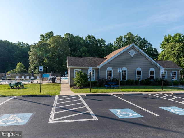 view of parking / parking lot with a yard