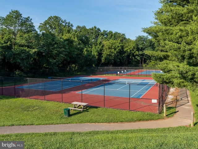 view of sport court featuring a yard