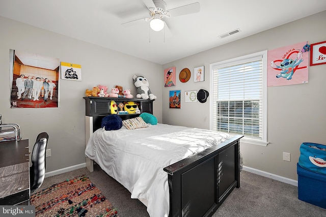 carpeted bedroom featuring ceiling fan and multiple windows