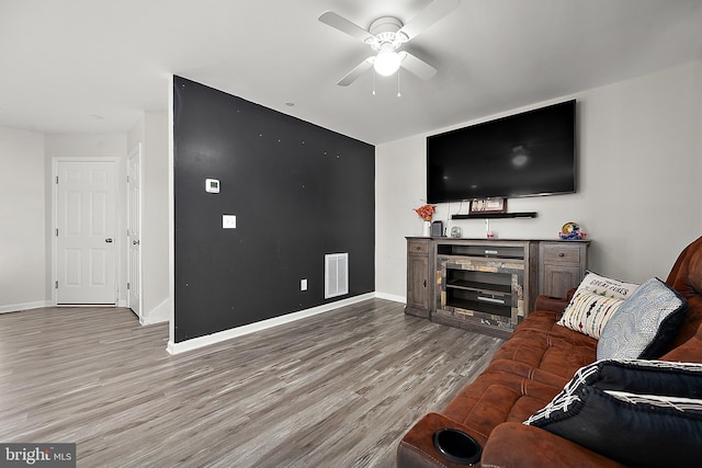 living room with ceiling fan and light hardwood / wood-style flooring