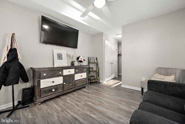 living room with ceiling fan and light wood-type flooring