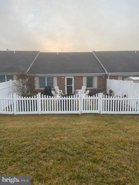 back house at dusk with a lawn