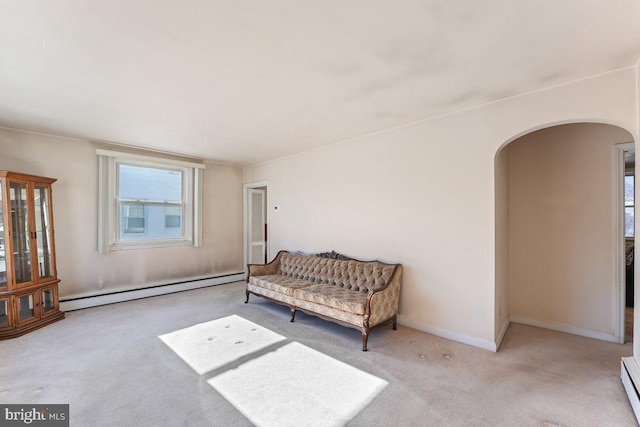 living area with light colored carpet and baseboard heating