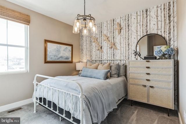 bedroom with a chandelier, carpet floors, and multiple windows