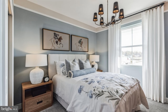 bedroom with carpet floors and a chandelier