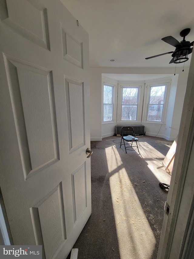 interior space with carpet flooring and radiator heating unit