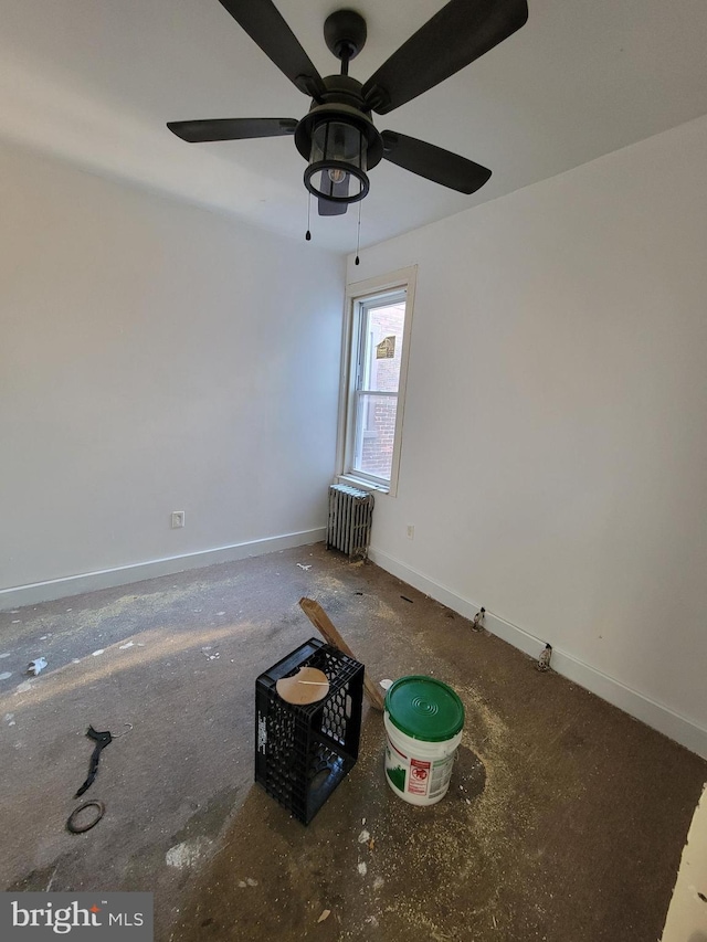 unfurnished room with radiator and ceiling fan