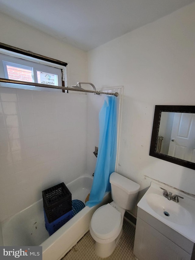 full bathroom with tile patterned flooring, shower / bath combination with curtain, vanity, and toilet