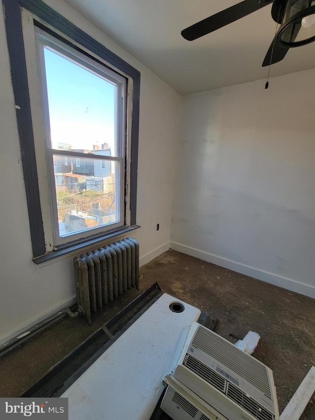 interior space featuring radiator and ceiling fan