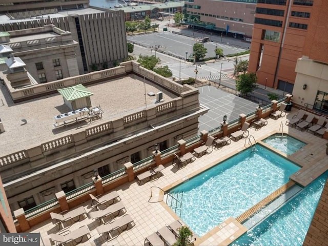 view of pool featuring a hot tub and a patio