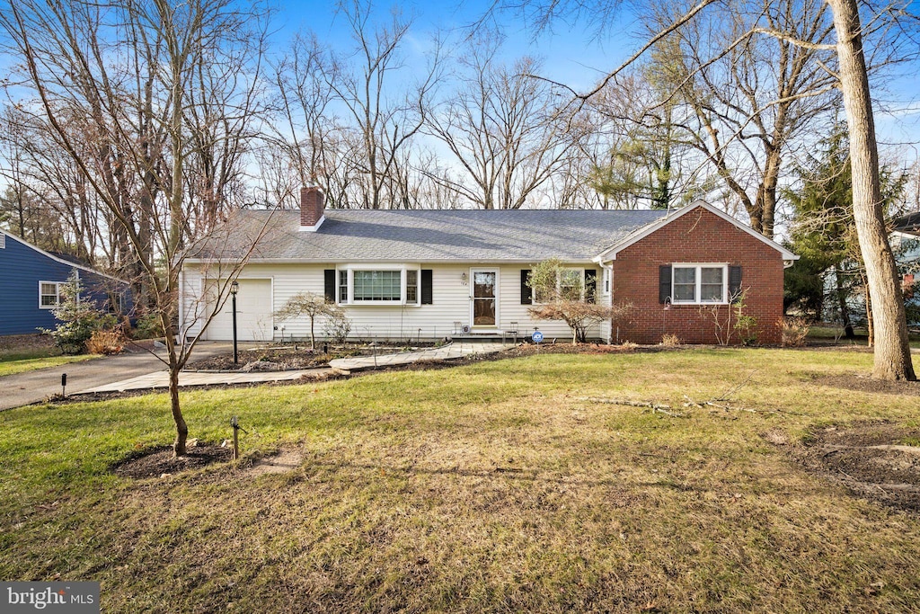 single story home with a garage and a front yard