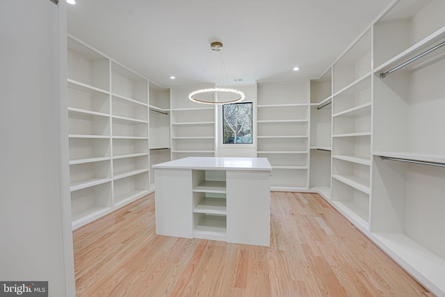 walk in closet featuring light hardwood / wood-style flooring