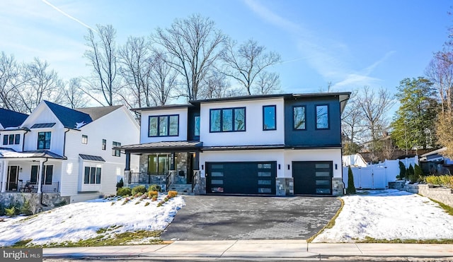 view of front of home featuring a porch and a garage