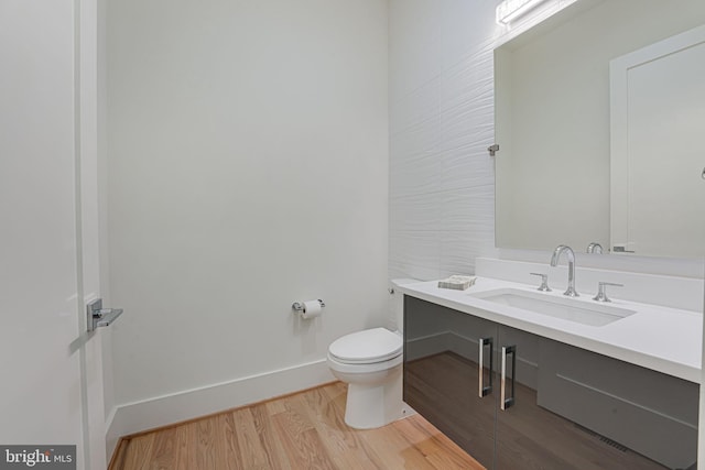 bathroom featuring vanity, toilet, and hardwood / wood-style floors