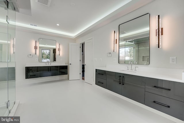 bathroom featuring vanity and a shower with door