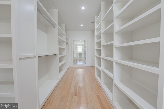 spacious closet with hardwood / wood-style floors