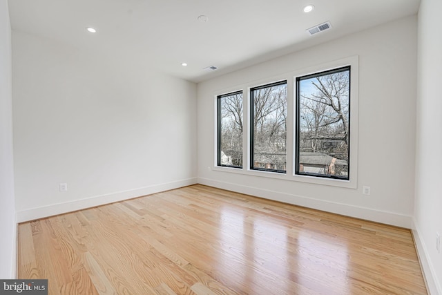 unfurnished room with light hardwood / wood-style flooring