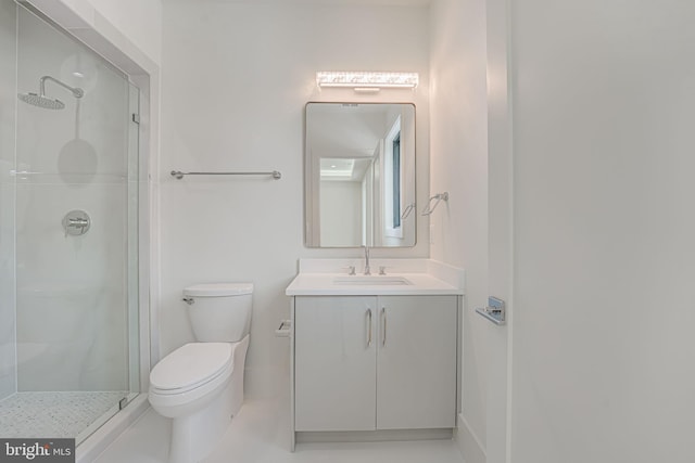 bathroom with vanity, a tile shower, and toilet