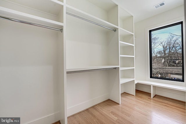 spacious closet with light hardwood / wood-style floors